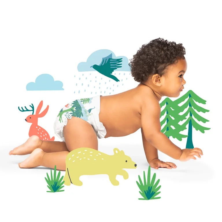 Baby crawling with illustrated forest animals.