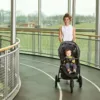 A woman and child in a stroller on the track.