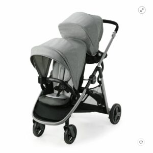 A stroller with two seats and wheels on it.