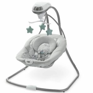 A baby swing with a remote control attached to it.