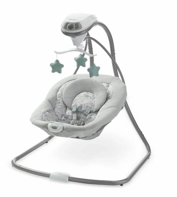 A baby swing with a remote control attached to it.