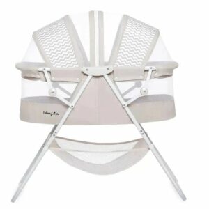 A white bassinet with two chairs and a net.