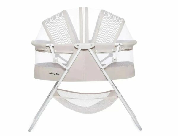 A white bassinet with two chairs and a net.