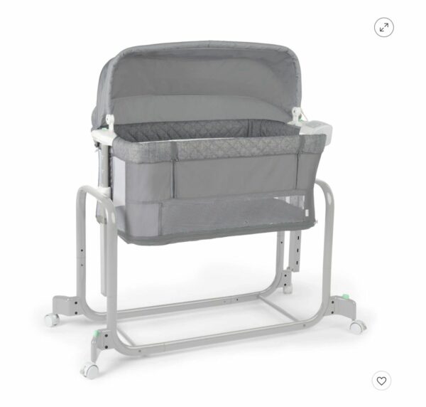 A baby bassinet with a grey cover on it.