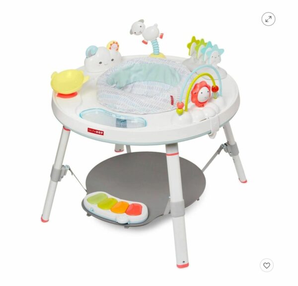 A baby 's activity center with a tray and table.