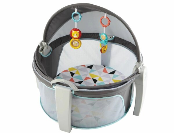 A baby bouncer with toys attached to it.