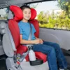 A boy sitting in the back of a car.