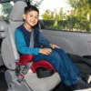 A boy sitting in the back of a car.