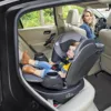 A woman and child in the back of a car.